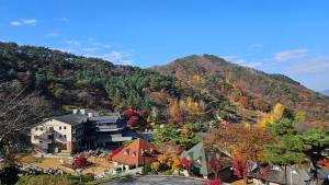 an aerial view of a building in front of a mountain at Nine Valley Park in Boeun