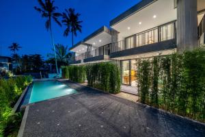 an exterior view of a house with a swimming pool at Townhouse T2 -Live Like a Local - Sophisticated Townhouse in Ubud in Ubud