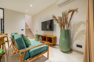 a living room with a couch and a large vase at Townhouse T2 -Live Like a Local - Sophisticated Townhouse in Ubud in Ubud