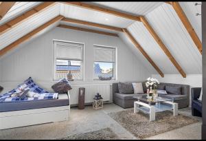 a living room with a couch and a table at Margaretenhof Apartment 2b in Wilhelmshaven