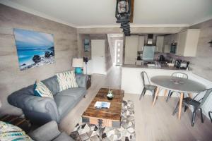 a living room with a couch and a table at Kirklea Island Suites in Tarbert