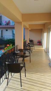 a row of tables and chairs on a balcony at Casa Dora Costinești in Costinesti
