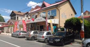 a group of cars parked on the side of a street at Casa Dora Costinești in Costinesti