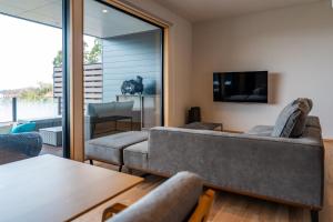 a living room with a couch and a tv at SETO CLAS for SLEEP B棟 in Takamatsu