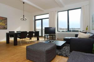 a living room with a couch and a table and chairs at Spacious Studio Apartment Friedrichshain in Berlin
