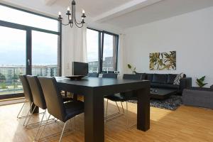 a living room with a black dining table and chairs at Spacious Studio Apartment Friedrichshain in Berlin