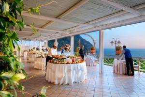 a wedding reception at a resort with tables with food at Sorriso Thermae Resort & Spa in Ischia +37 photos