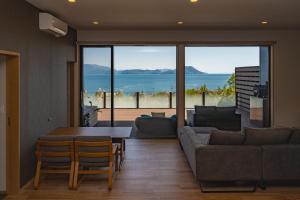a living room with a couch and a table at SETO CLAS for SLEEP B棟 in Takamatsu