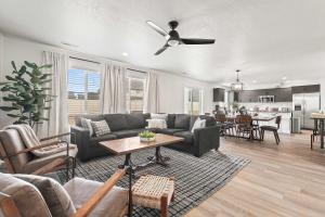 a living room with a couch and a ceiling fan at 6BR Retreat with Playground Basketball & Sleeps 22 in Star