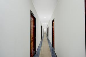 an empty corridor of a building with a long hallway at Super Townhouse Nagole RTO Office in Upal