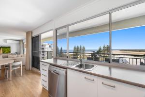 a kitchen with a view of the ocean at Oceanfront 3-Bed Retreat with Pool-Steps to Beach in Caloundra