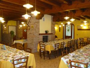 a large dining room with tables and chairs and lights at Agriturismo Ae Noseare in Torri di Quartesolo