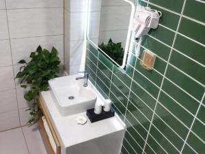 a bathroom with a sink and a mirror at GreenTree Inn Jining Jianshe Road Hotel in Jining