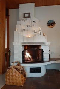 a living room with a fireplace with white bricks at The Aurora Nest by Hilla Villas in Saariselka