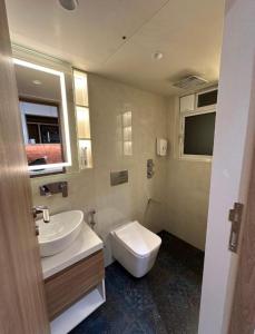 a bathroom with a white toilet and a sink at Hotel the haveliya-1 mint from new delhi railway station & connaught place in New Delhi