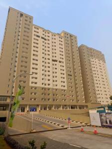 a large apartment building with a road in front of it at Antareja LoftVilles By Reccoma in Dukuh