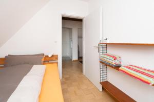 a bedroom with a bed and a book shelf at Kleine Koje Heide in Heide