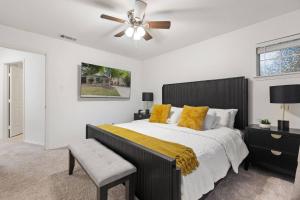 a bedroom with a large bed and a ceiling fan at Luxury Getaway: 2 King Suites, Pool & Grill in Flower Mound +22 photos