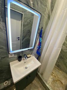 a bathroom with a sink and a mirror at Аэропорт Мечеть ЭКСПО in Astana