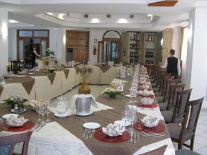 a long dining room with a long table and chairs at Hotel Ristorante Antica Marina in Nicotera Marina