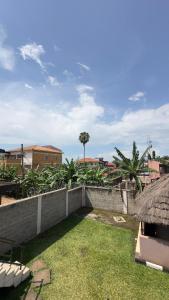a view of a building with a grass roof at Karibu motel mbale in Mbale