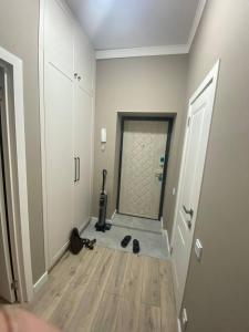 an empty room with a hallway with a door and a floor at Brick house in Astana