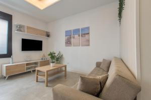 a living room with a couch and a tv at Modern Loft in Málaga in Málaga