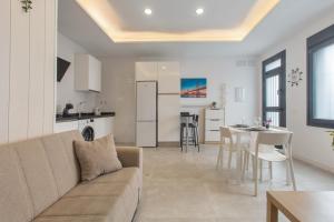 a living room and kitchen with a couch and a table at Modern Loft in Málaga in Málaga