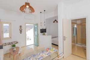 a living room with a couch and a table at Chora Sea View Residence in Astypalaia Town +6 photos