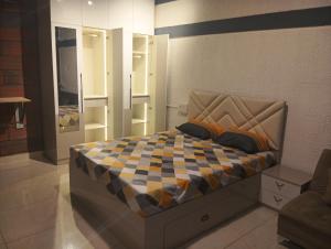 a bedroom with a bed with a checkeredkered at Rustic Roots Inn in Bangalore