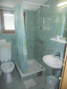 a bathroom with a toilet and a sink and a shower at Sobe JASNA in Međugorje