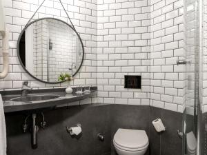 a bathroom with a sink and a toilet and a mirror at Ibis Istanbul Zeytinburnu in Istanbul