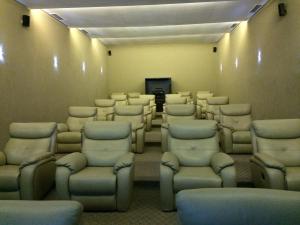 a large room with chairs and a flat screen tv at La Isla Gran Cayman 904 in Acapulco +91 photos