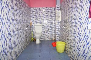a bathroom with a toilet and two buckets at Entire 1BHK & 2BHK private apartments with personal kitchen, 767ooo54oo, TAJ RESIDENCY Holiday Homestay in Jorhat +33 photos