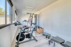 a room with a gym with a treadmill and weights at Villa Virginie gite 2 in Faudoas