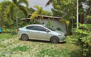 a silver car parked in front of a house at Lanta Vacation House in Ko Lanta Yai