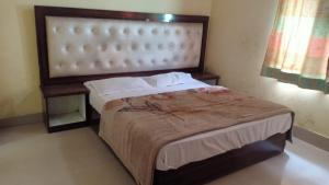 a bedroom with a large bed in a room at BS Residency in Dehradun +4 photos