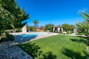 a yard with a swimming pool and a gazebo at Villa Martina in San Vito dei Normanni