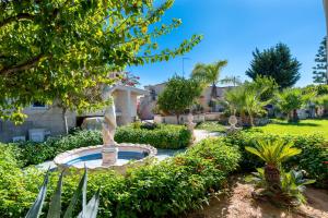 a fountain in the middle of a garden at Villa Martina in San Vito dei Normanni