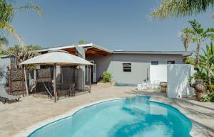 a swimming pool in front of a house at NJ SKY GUESTHOUSE & BOUTIQUE windhoek in Windhoek