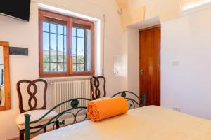 a room with a table and two chairs and a window at Villa Martina in San Vito dei Normanni +35 photos