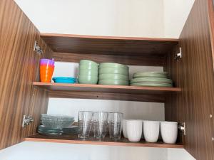 a cabinet filled with plates and bowls and glasses at Casa Andares in Colima