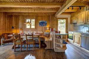 a kitchen and dining room with a table and chairs at Chalet Brunello in La Tzoumaz +17 photos