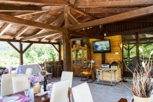 a dining room with wooden ceilings and a tv at B&B Villa Nena in Plitvica Selo