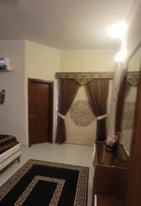 a living room with curtains and a door at Luxurious 200 SQY Executive Furnished Villa for Rent in Karachi