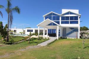 a large white house with a lot of windows at Private Villa w Pool BBQ Up to 25Guests in Pajarito