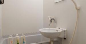 a white bathroom with a sink and a bath tub at Cosmo Mercy N-1 / Vacation STAY 12990 in Tokyo