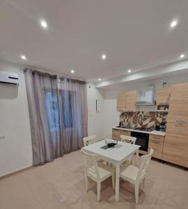 a kitchen with a table and chairs in a room at Le casette di Elia e Alice in Palermo