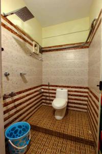 a bathroom with a toilet in a room at Vembanad Village Backwater Resort by EGH in Alleppey