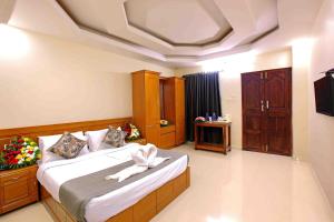 a hotel room with a bed with a towel on it at Vembanad Village Backwater Resort by EGH in Alleppey